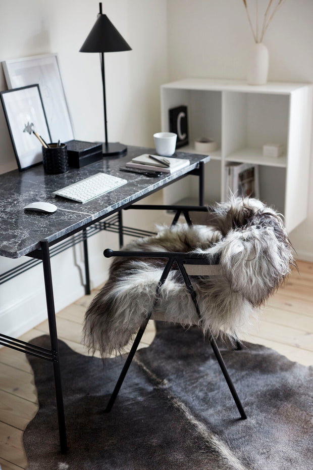 graues Lammfell auf einem Schreibtischstuhl